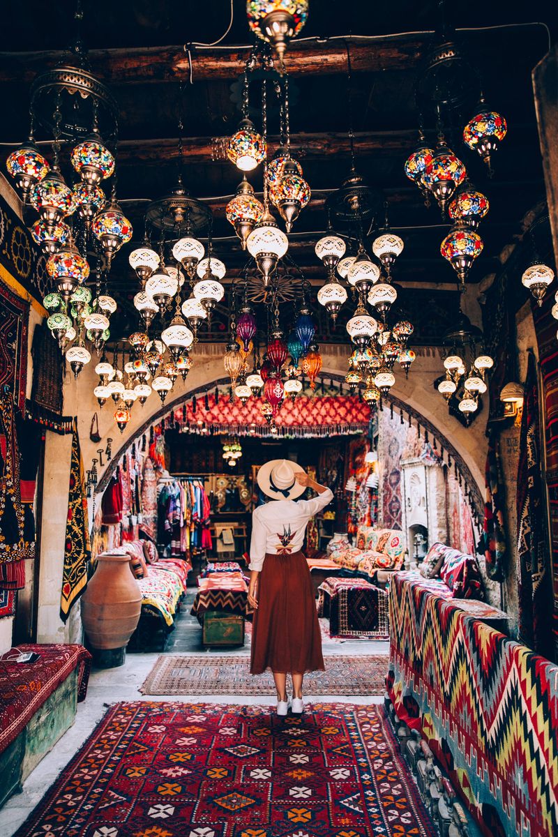 Guest standing under hundreds of glowing mosaic lanterns in a Cappadocia shop